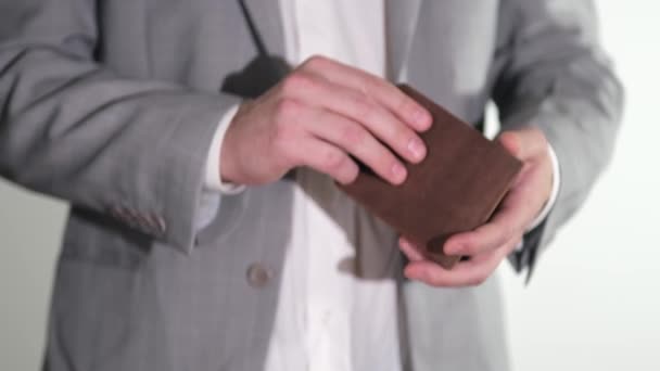 The man opens a leather wallet and counts the cash. Save money on various payments and expenses. Close up — Stock Video