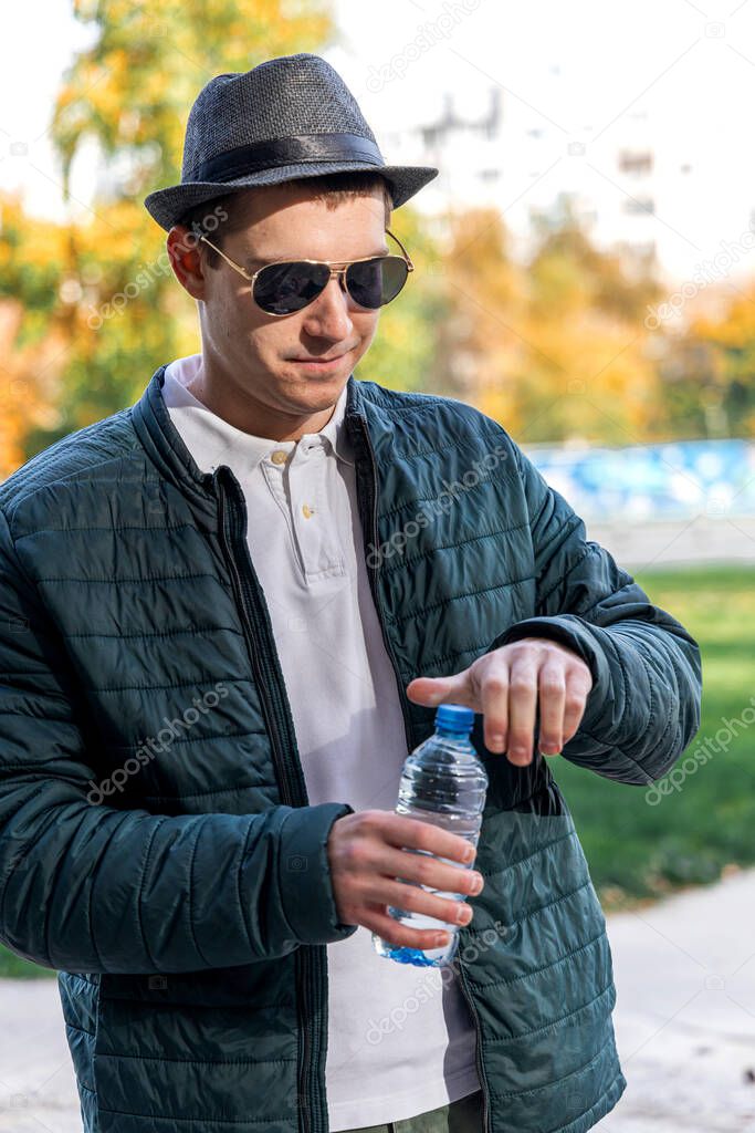 Young man in the park with the bottle