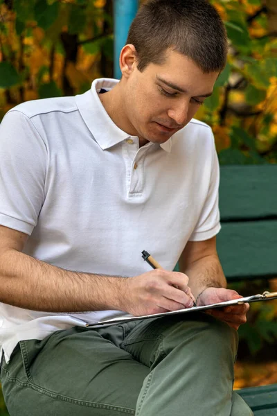 Man Writes Notebook His Knee Stock Picture