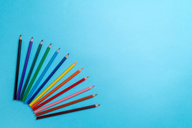 Mavi arka plan üzerinde renkli kalemler. Sanat okulu için boş, okula geri dön. Kopyalama alanı