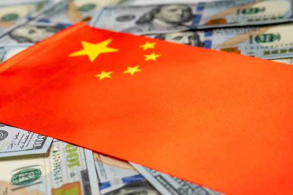 China flag with US dollars as background. Concept for investors, soft focus