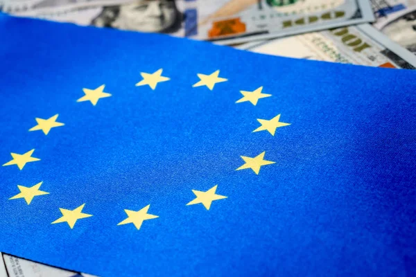 stock image European Union flag with US dollars as background. Concept for investors, soft focus