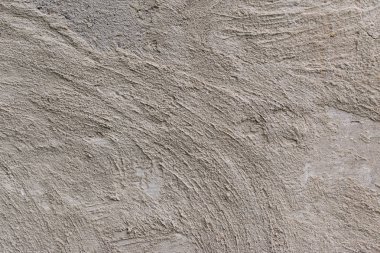 Soyut bir arka plan olarak sarı ve kahverengi lekeler ile eski gri beton duvar