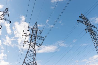 Gökyüzüne karşı güçlü güç telleri ile metal direkleri yüksek voltajlı teknolojik güç hatları