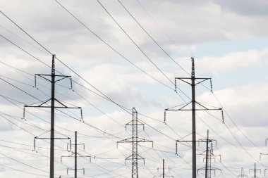 Gökyüzüne karşı güçlü güç telleri ile metal direkleri yüksek voltajlı teknolojik güç hatları