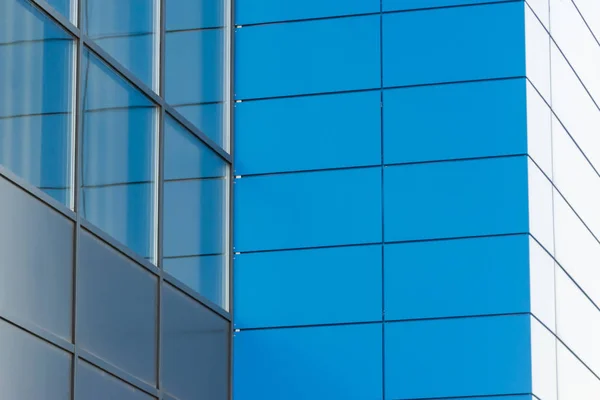 Geometric colored building facade elements with planes, lines and corners with light flare and reflections for an abstract background and texture of white, blue, gray colors. Place for text