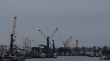Working cranes, cloudy light in the dordrecht port, Netherlands