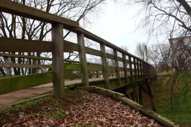 Wooden railing of wood bridge, autumn season