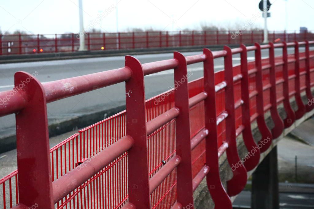 Metalic red railing of road bridge