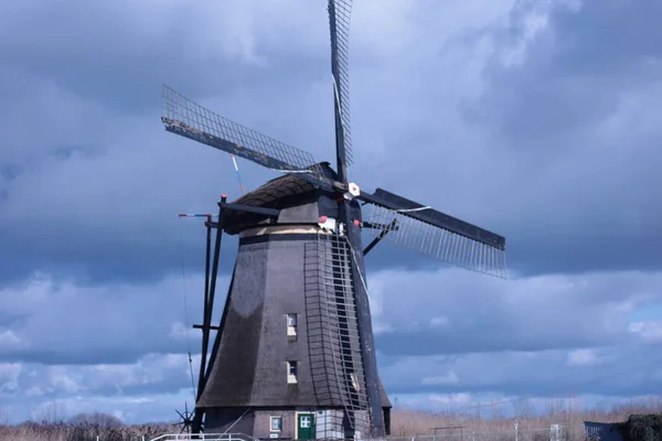 windmill of kinderdijk , beautiful netherlands landscape with sky and clouds, historical travel photo