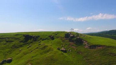 Tepenin havadan görünümü, kırsal alan, doğal dağ taşları ve çim