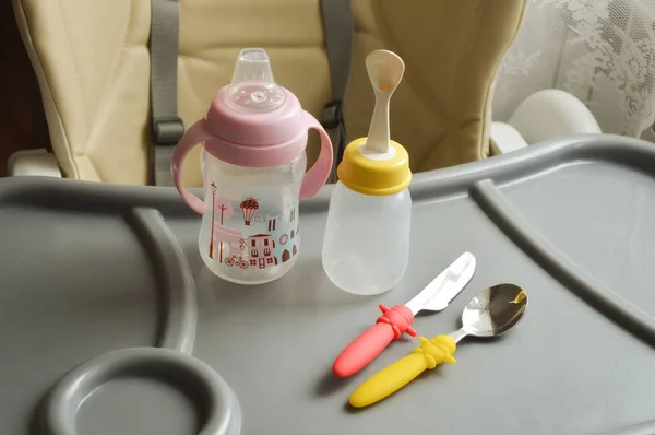 baby food items, bottle, spoon and knife.