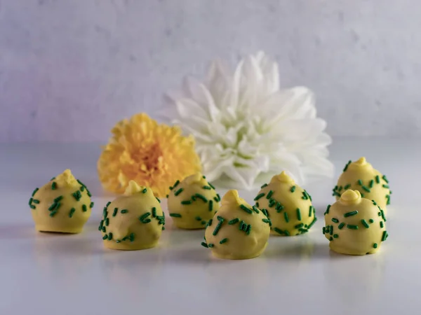 Pineapple Upside Cake Balls Yellow Coating Green Sprinkles Sitting White — Stock Photo, Image