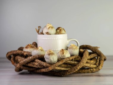 Cappuccino kek topları, ortasında beyaz bir kahve fincanı olan tahta bir çelengin üzerine serpiştirilmiş espresso tozu gibi mantarlar. Tatlı topları, lezzetli ve lezzetli.!