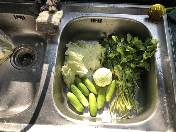 fresh vegetables in kitchen sink