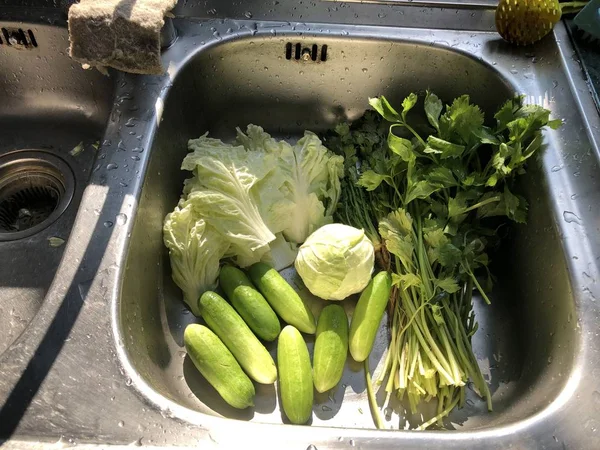 fresh vegetables in kitchen sink