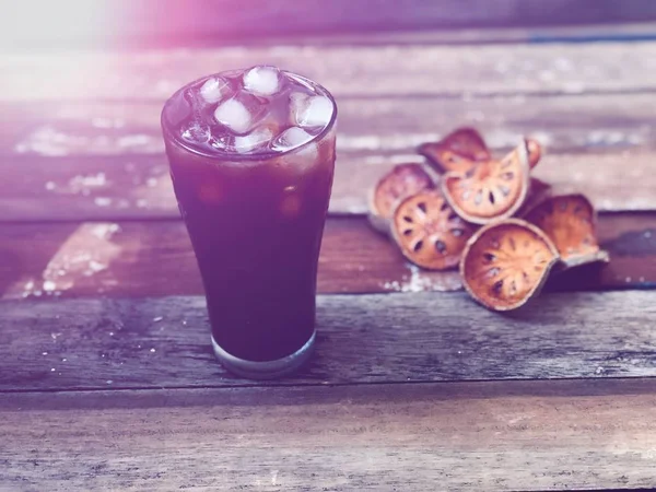 Iced Coffee Glass Blurred Dry Bael Fruit Wood Table Top — Stock Photo, Image