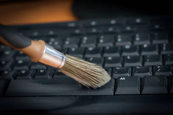 Cleaning the dirty keyboard with brush