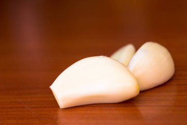 peeled garlic on the table clipart