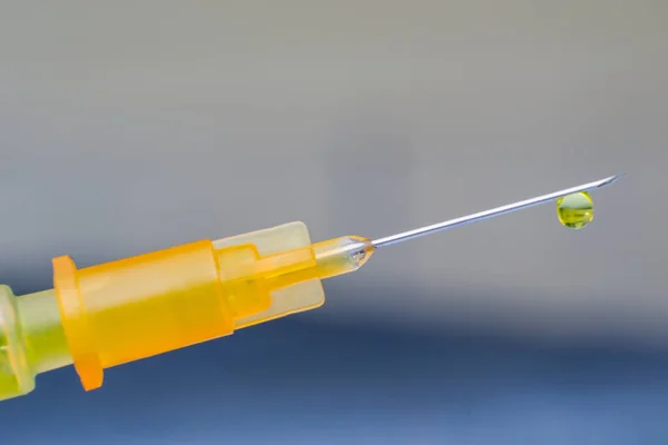 hypodermic needle with one drop of drug on his peak