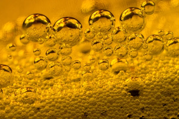 Air bubbles in golden liquid abstract — Stock Photo, Image