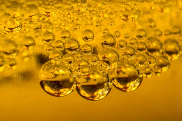 Air bubbles in golden liquid abstract — Stock Photo, Image