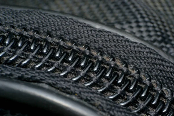 Black textile accessories material zipper macro on blur backgrou Royalty Free Stock Images