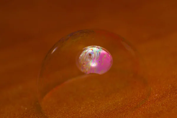 pink soap bubble inside a transparent bubble