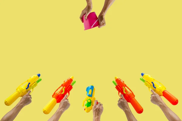 Hands holding water gun and bucket for Water or Songkran festival.