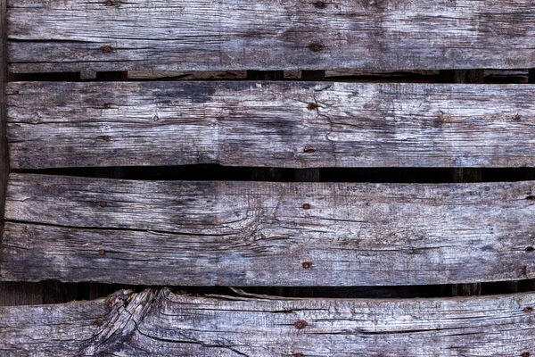 Old, gray boards fastened with rusty nails. — Stock Photo, Image