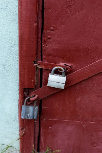 Two gray locks on a burgundy door. Perfect protection. — Stock Photo, Image