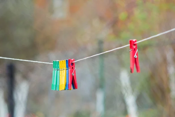 Colorful clothespins on a clothesline in village