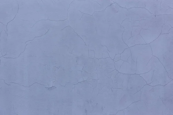 Серая цементная стена с трещинами — стоковое фото