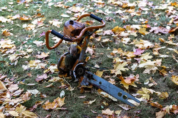 Broken chainsaw on the grass — Stock Photo, Image