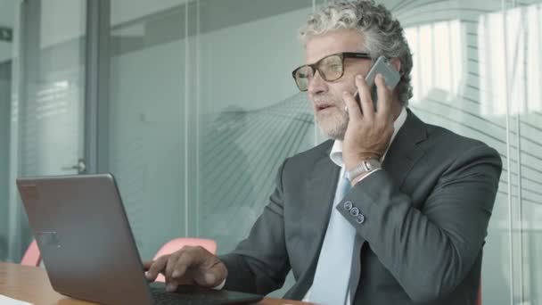 CEO maduro enfocado usando traje y gafas — Vídeos de Stock