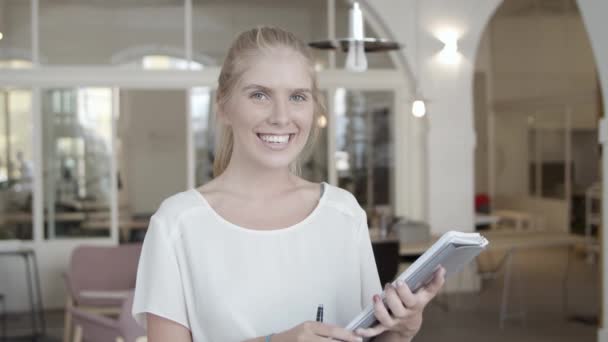 Pretty fair haired young woman holding documents — Stock Video