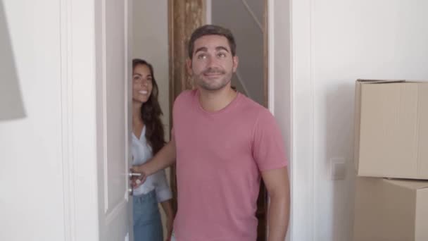 Sonriente chico abriendo la puerta blanca, entrando en la habitación — Vídeos de Stock