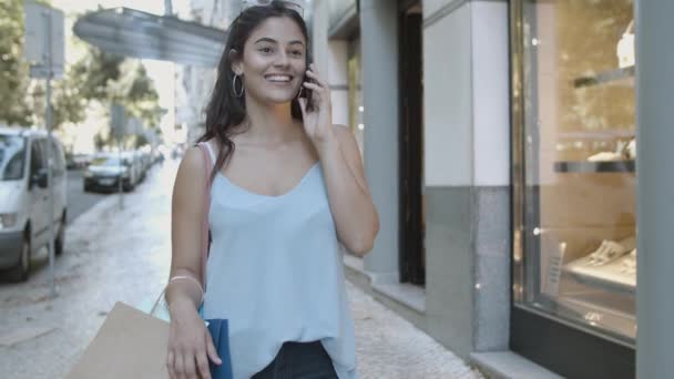 Jovem feliz de pé na rua em falar ao telefone — Vídeo de Stock