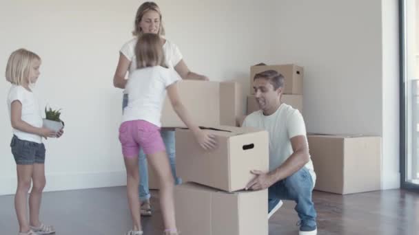 Pozitif ebeveynler ve iki kız taşınmak için eşya hazırlıyorlar. — Stok video