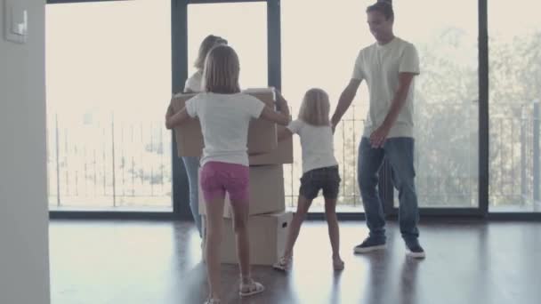 Szülők és két lány ünneplik, hogy új lakásba költöztek. — Stock videók