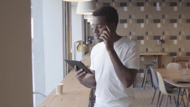 Allvarlig afroamerikansk ung man talar på mobiltelefon — Stockvideo