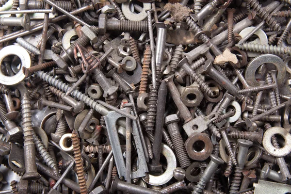 Eski paslı civatalar, fındık, vida, köşeli ayraçlar, çeşitli metal Ayrıntılar arka plan