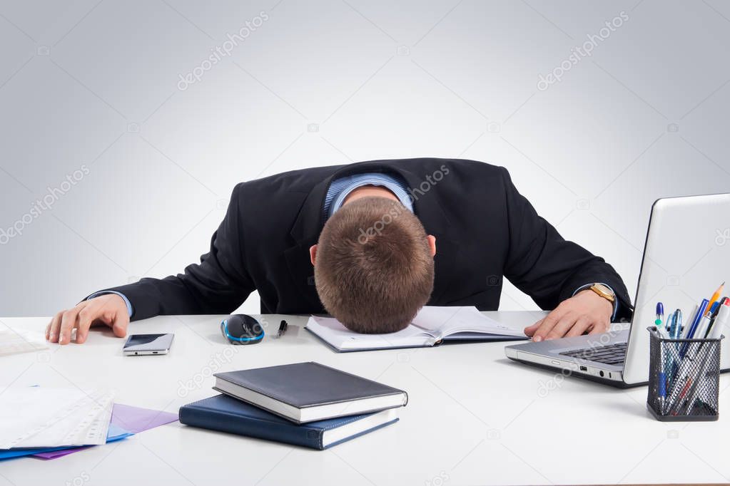 Office,technology, finances, internet, business, success and people concept-Exhausted businessman falling asleep at his office desk