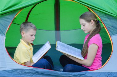 Kız ve erkek çadırda bir kitap okumak