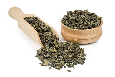 Beyaz arka plan üzerinde izole bir ahşap kürek ile gevşek yeşil çay