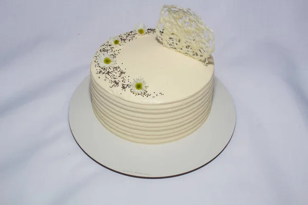 white and yellow cake on tray on white background
