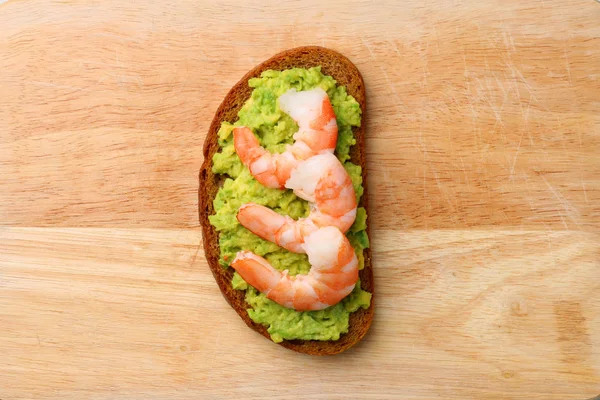 shrimp with avocado sandwich on wood top view