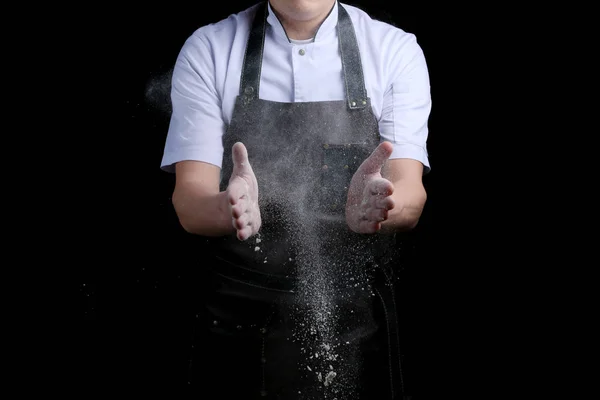 Chef hands in flour on black background. clap with flour. baking bread and and making pizza or pasta