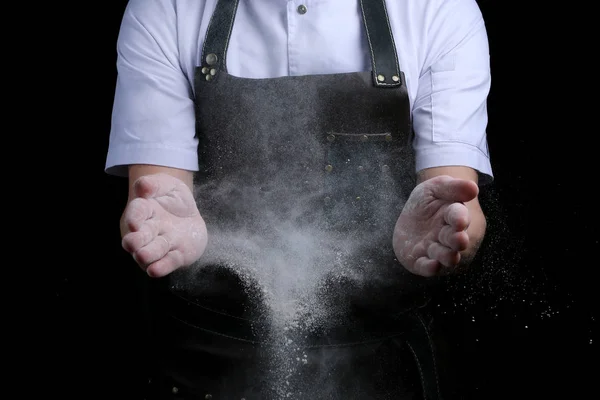 Chef hands in flour on black background. clap with flour. baking bread and and making pizza or pasta