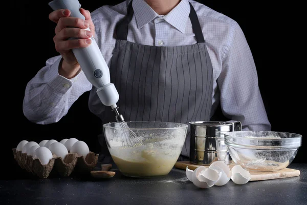 sifting flour in bowl. man cooking dessert concept